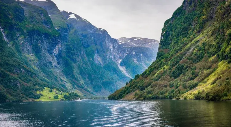 The Mostraumen strait, where the fjord narrows between steep green cliffs